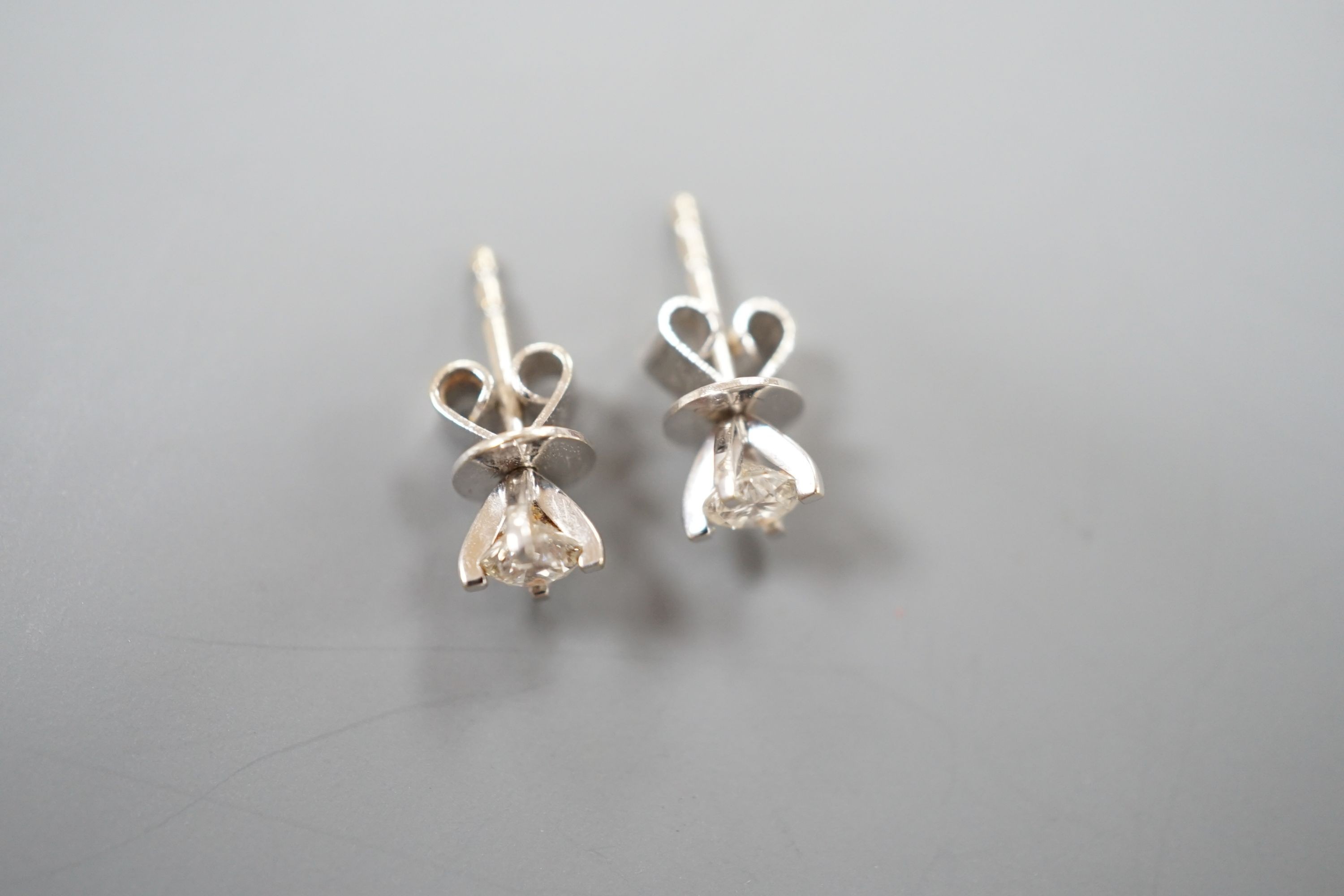 A pair of 750 white metal and solitaire diamond set ear studs, the stones measuring 3.5mm in diameter, gross weight 1.1 grams.